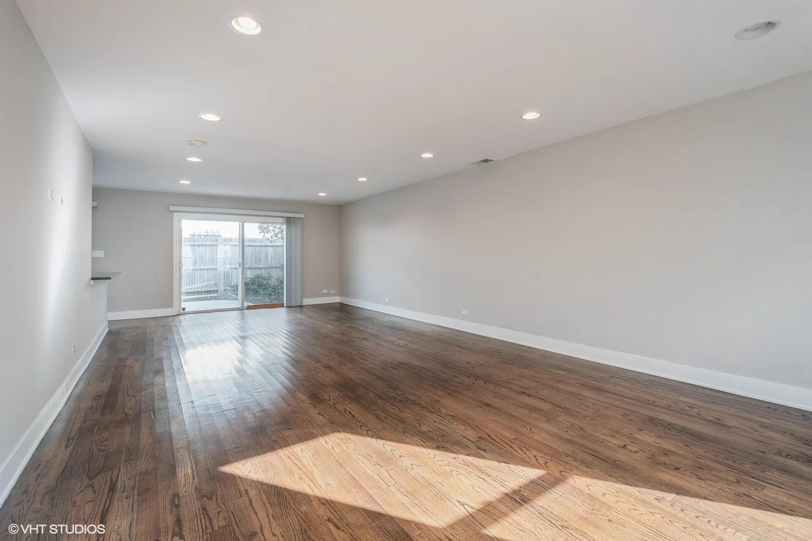 Living and dining space with sliding door to the backyard