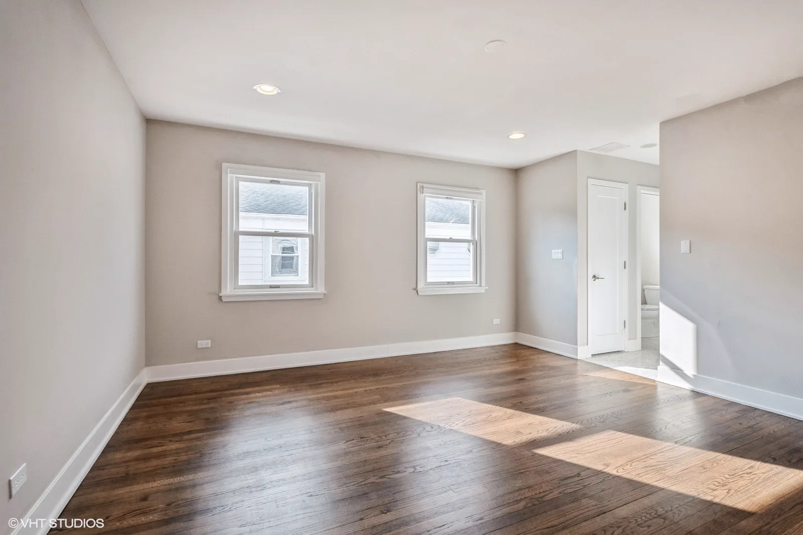Primary bedroom with hardwood floors